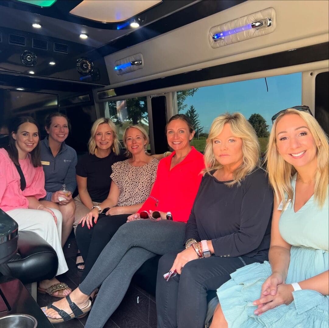 Group of women celebrating inside a Stop & Go Airport Shuttle Service, Inc. party bus