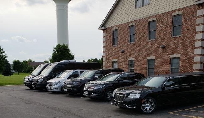 Full lineup of Stop & Go Airport Shuttle Service, Inc. fleet vehicles in parking lot