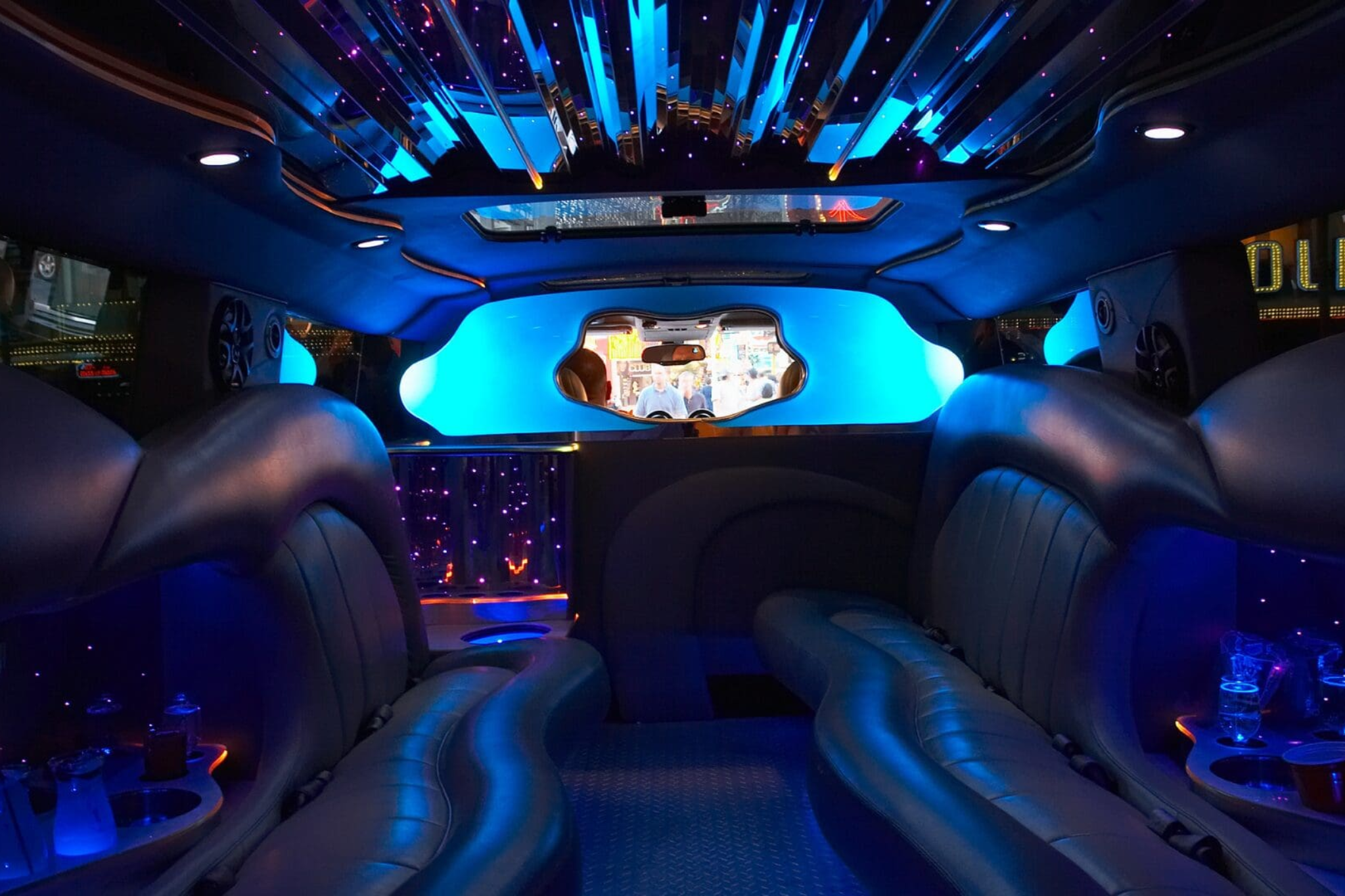 Interior of a Stop &amp; Go luxury stretch limousine with ambient lighting and plush seating