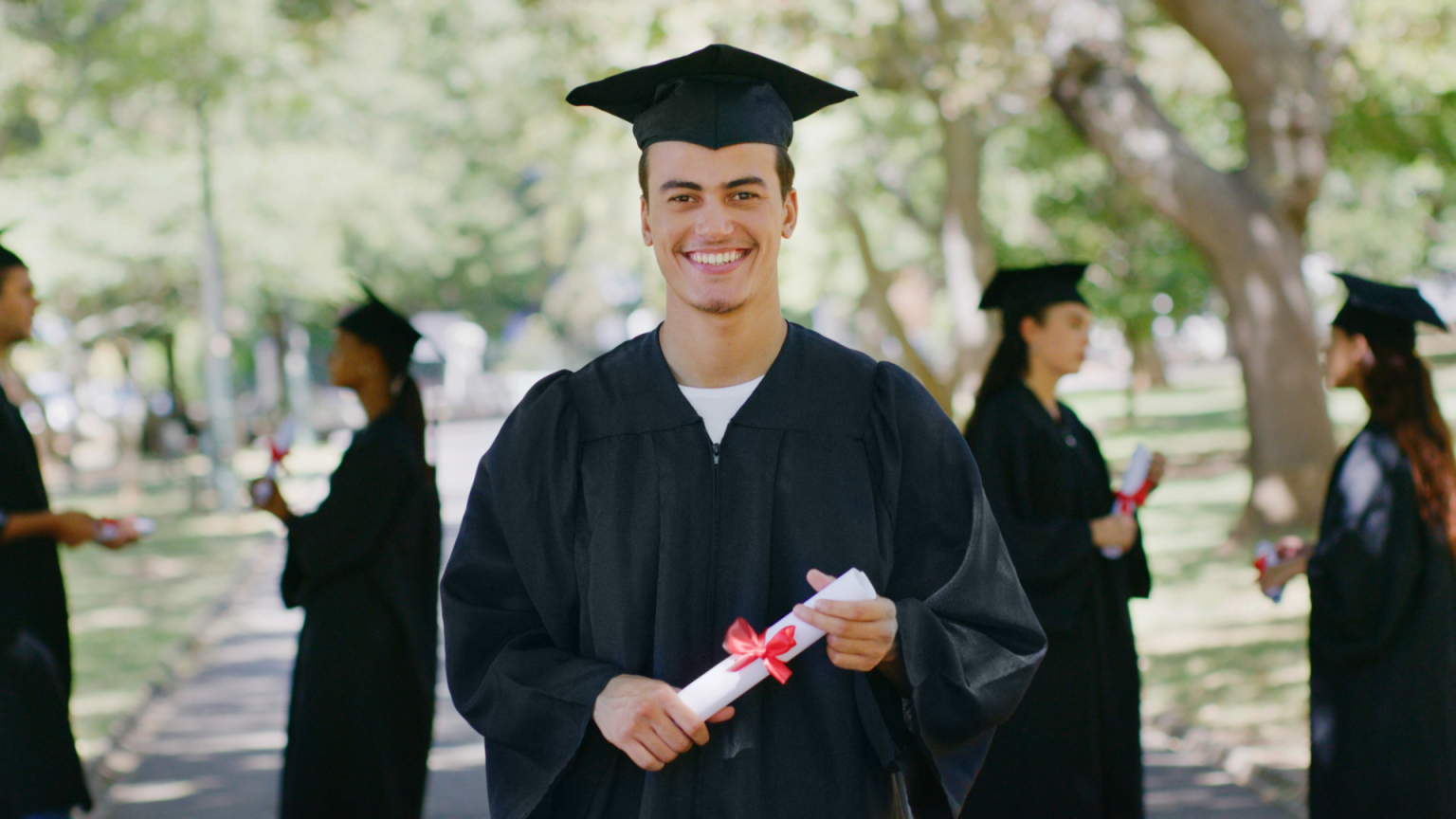 Smiling graduates celebrating on graduation day with Stop and Go Limo