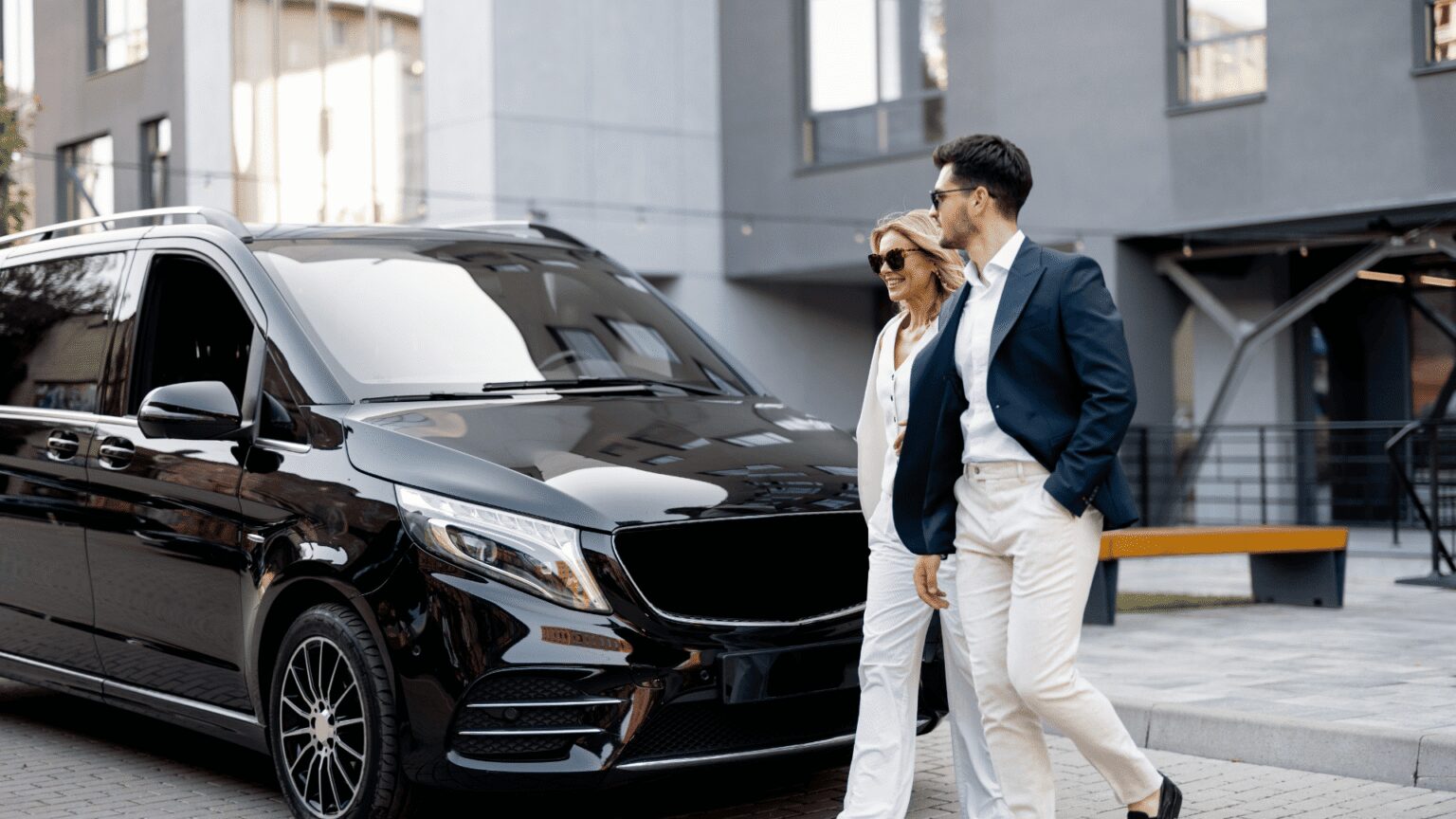 Chauffeur walking a client to a black luxury SUV