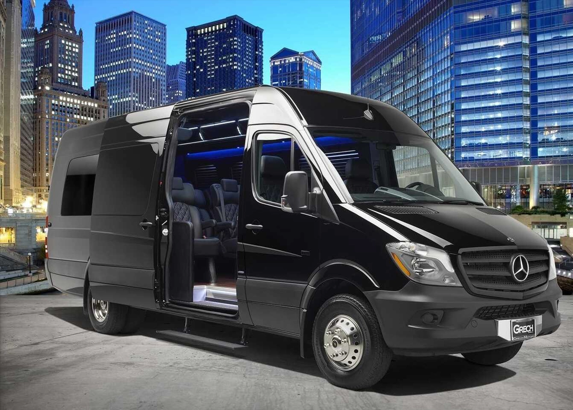 A black van parked in front of some buildings