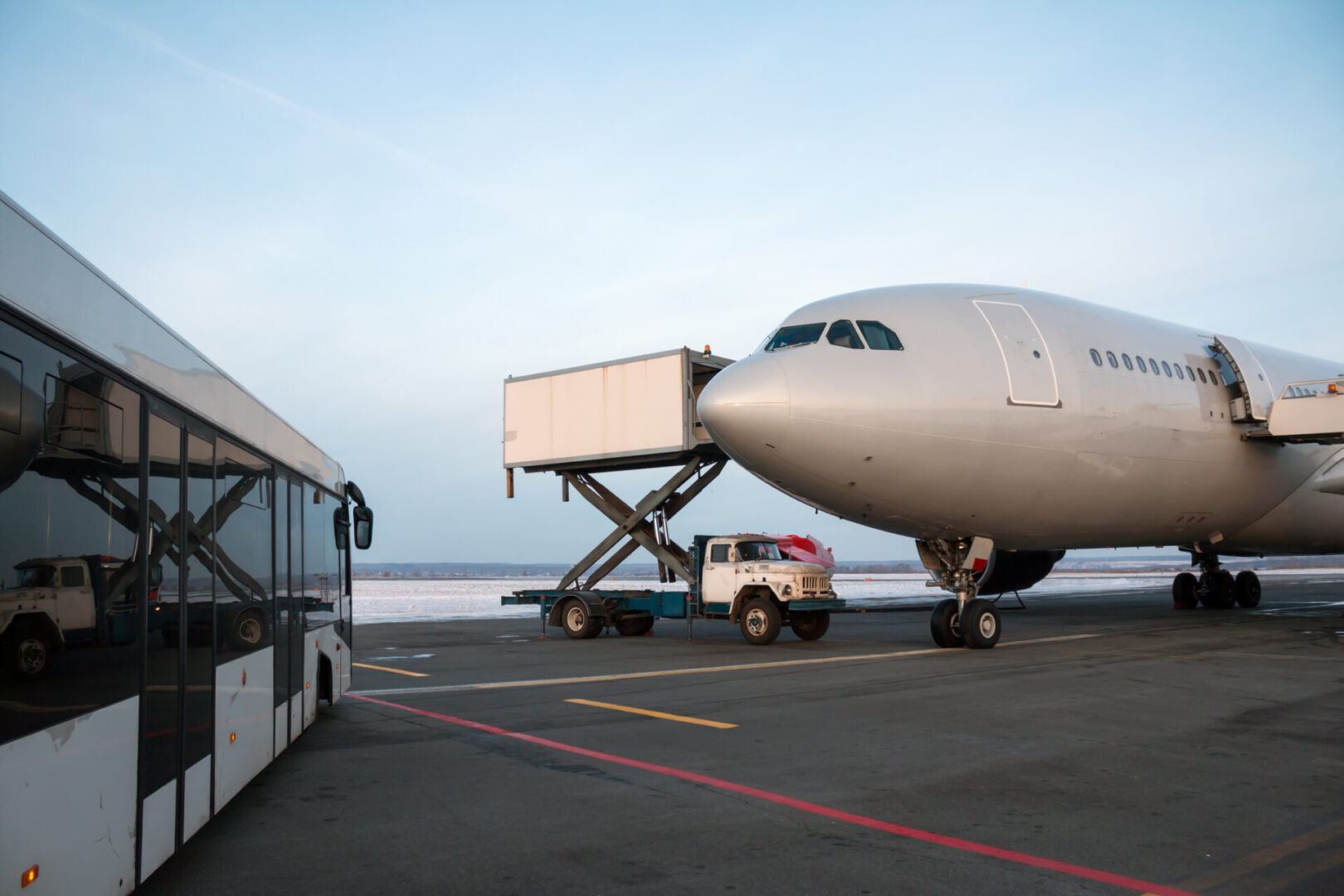 A large airplane is being loaded onto the tarmac.