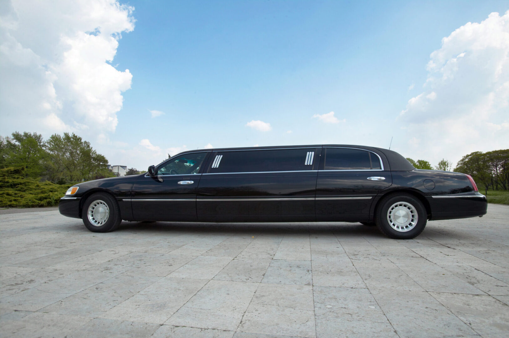 A black limo is parked in the parking lot.